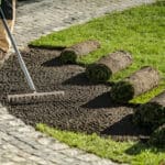 A lush, newly installed green sod lawn with no weeds in a backyard in Macomb, Michigan.